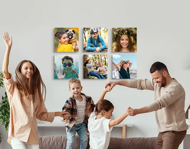 A family dancing around with canvas photos on the wall behind them. Provided by MyPictures.co.uk