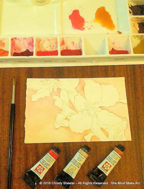 One of the cherry blossoms watercolor paintings in its beginning stages.  The three tubes of watercolor used for the background.