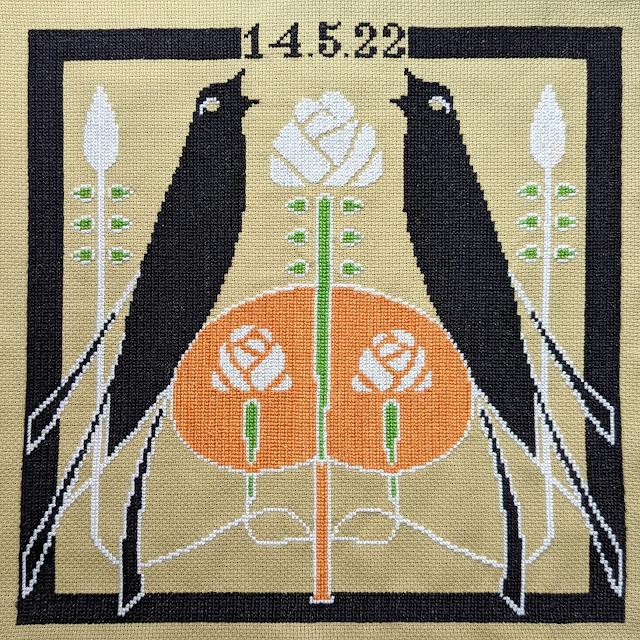 cross stitch of two crows and art nouveau style roses