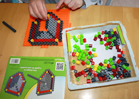 The Perler Dragon Slayer kit includes beads to make a shield, sword and dragon. Tessa started off by piecing together the shield.