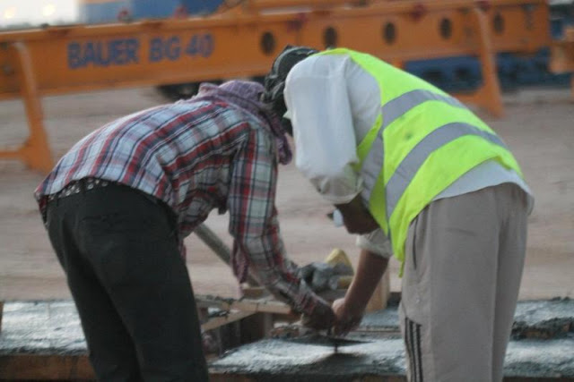 Picture of two workers working with concrete on the Kingdom Tower construction site