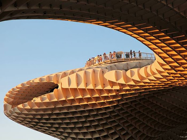 Metropol Parasol is a wooden structure located at La Encarnación square, in the old quarter of Seville, Spain. Designed by German architect Jürgen Mayer-Hermann, the structure resembles a grove of prefabricated wooden trees soaring 26 meters into the air. It has dimensions of 150 by 70 metres and claims to be the largest wooden structure in the world. 