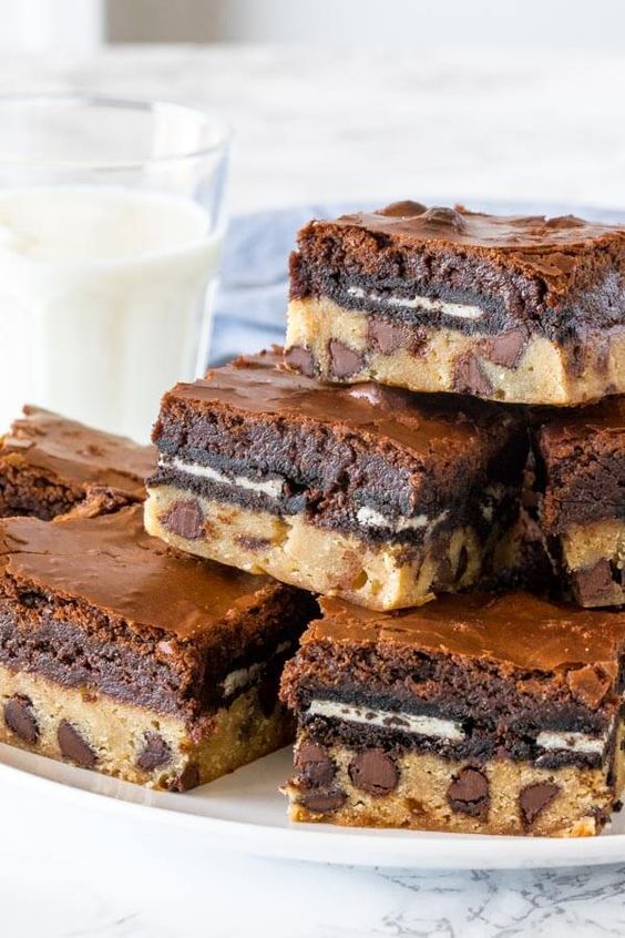These slutty brownies are the most over-the-top dessert you'll ever try. They have a soft and chewy chocolate chip cookie base, a layer of Oreo cookies, and fudgy brownie on top! This recipe is 100% from scratch and definitely the most indulgent brownie recipe around.