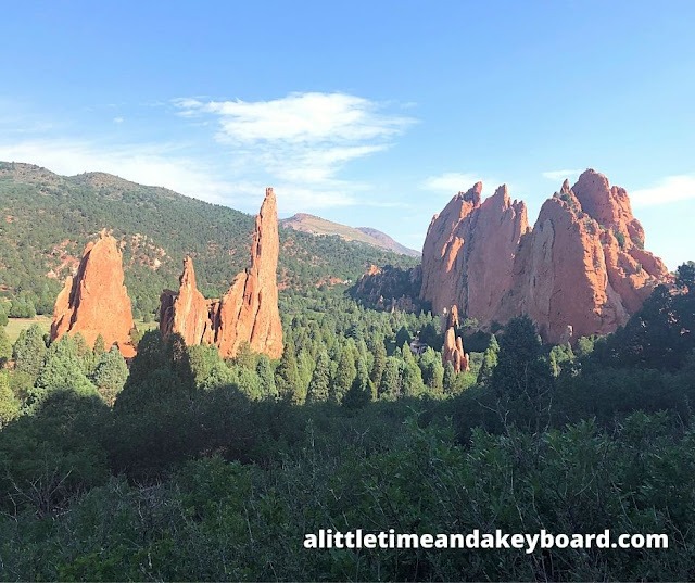 Distinctive rock formations rise above the evergreens.