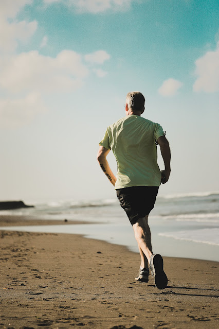 person running on beach:Photo by Aan Nizal on Unsplash