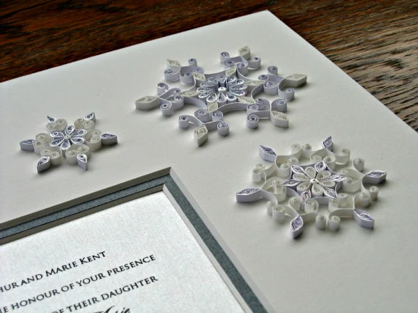 three quilled snowflakes on double mat wedding invitation