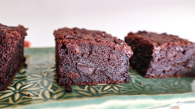 side profile of 3 large chocolate mochi brownies on a hand made tray