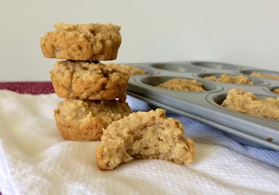 Finished applesauce barley infant cereal mini muffins showing one with a bite out of it..