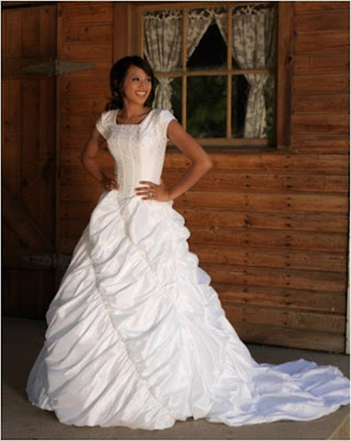 This taffeta modest wedding gown has boning in the bodice with bead