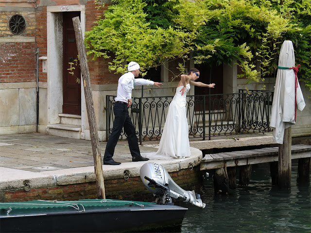 Bride and groom swim for the photographer, Rio di San Lorenzo, Castello, Venice