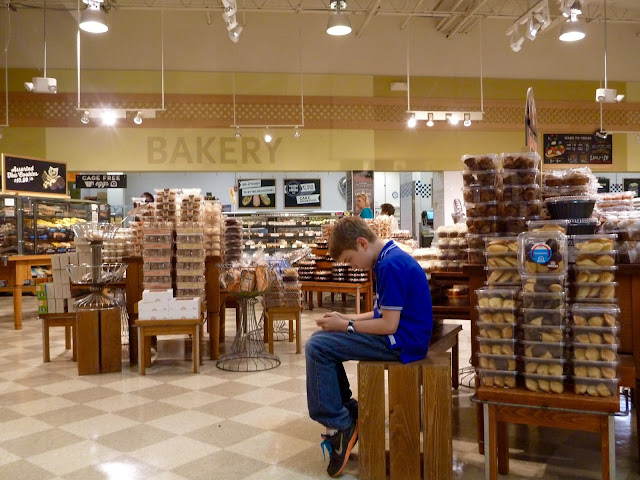 boy in grocery store with smartphone