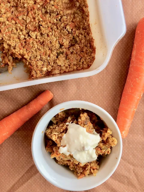 Baked carrot cake oatmeal in a pan and some in a serving bowl.