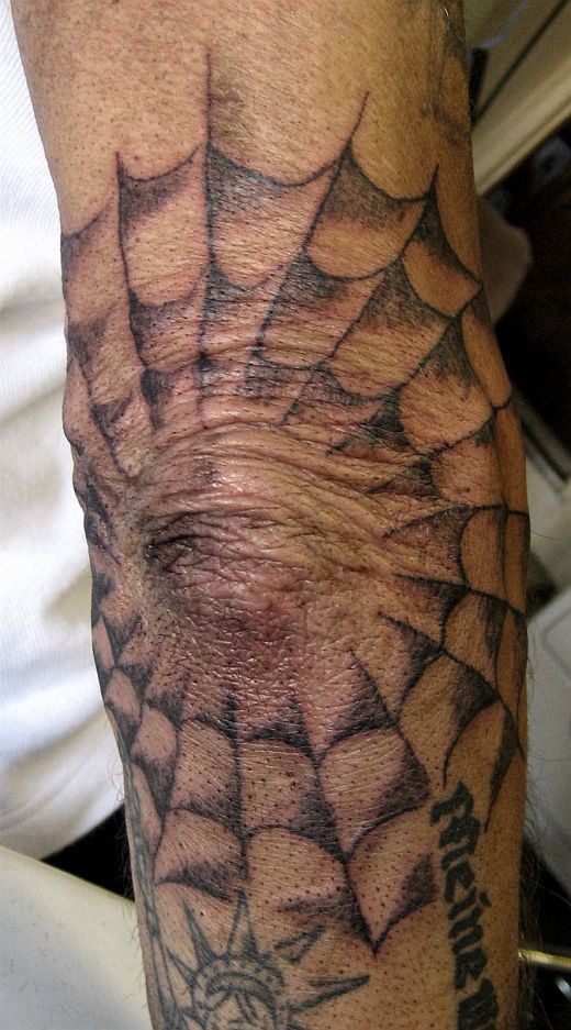 spider web tattoo on elbow