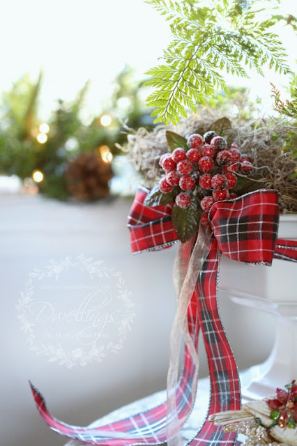 Red berries dress up an ironstone compote willed with a rabbits foot fern.