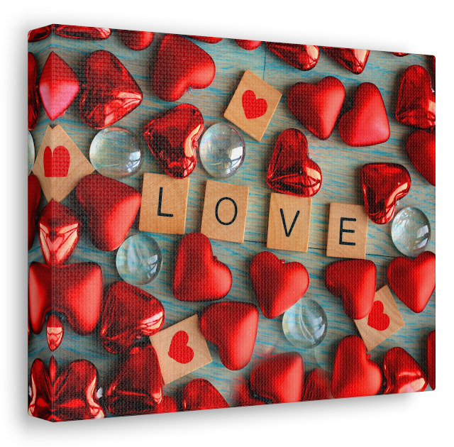 Valentine Canvas Gallery Wrap With Love Hearts Shapes with the Text Love Spelled Out in Wooden Square On the Green Wooden Background