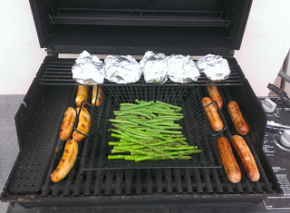 grilling sausage, potatoes, and fresh vegetables