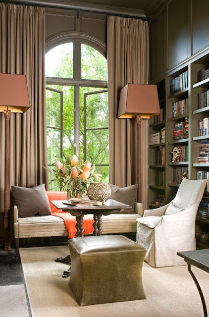 beautiful brown and cream living room den with orange hermes blanket gray painted built in bookcases