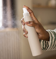 "A variety of heat protectant sprays displayed, essential for prepping hair before heat styling to prevent damage and to make your Hairstyle last longer."