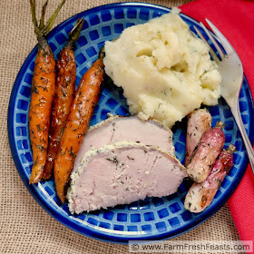 overhead image of a plate of roasted carrots with fresh dill, mashed potatoes, and roast pork