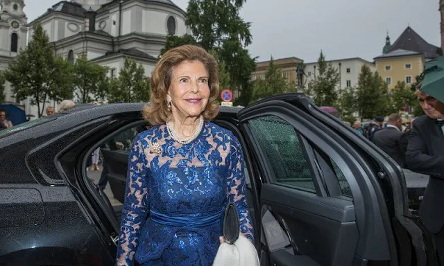 Queen Silvia wore a royal blue lace gown and navy suede pumps. Diamond earrings. Princess Madeleine and Princess Adrienne