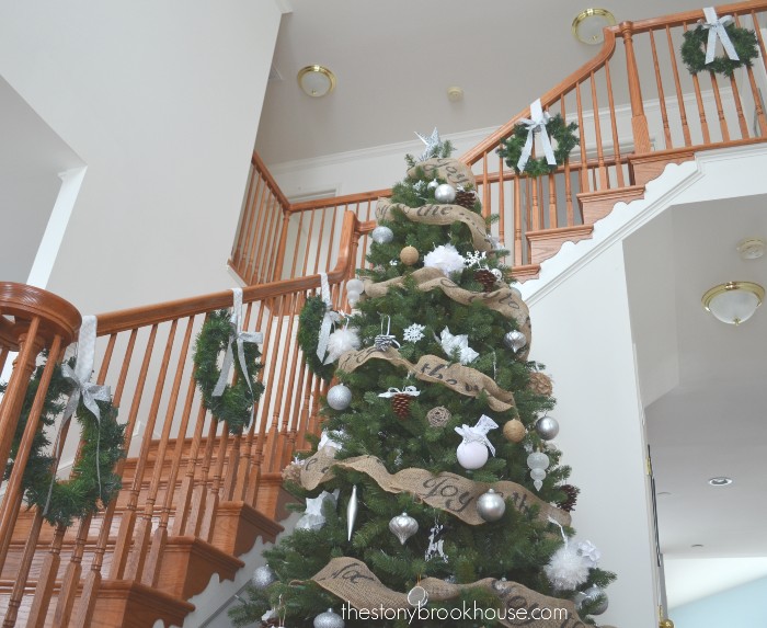 Hanging Dollar Tree wreaths on staircase