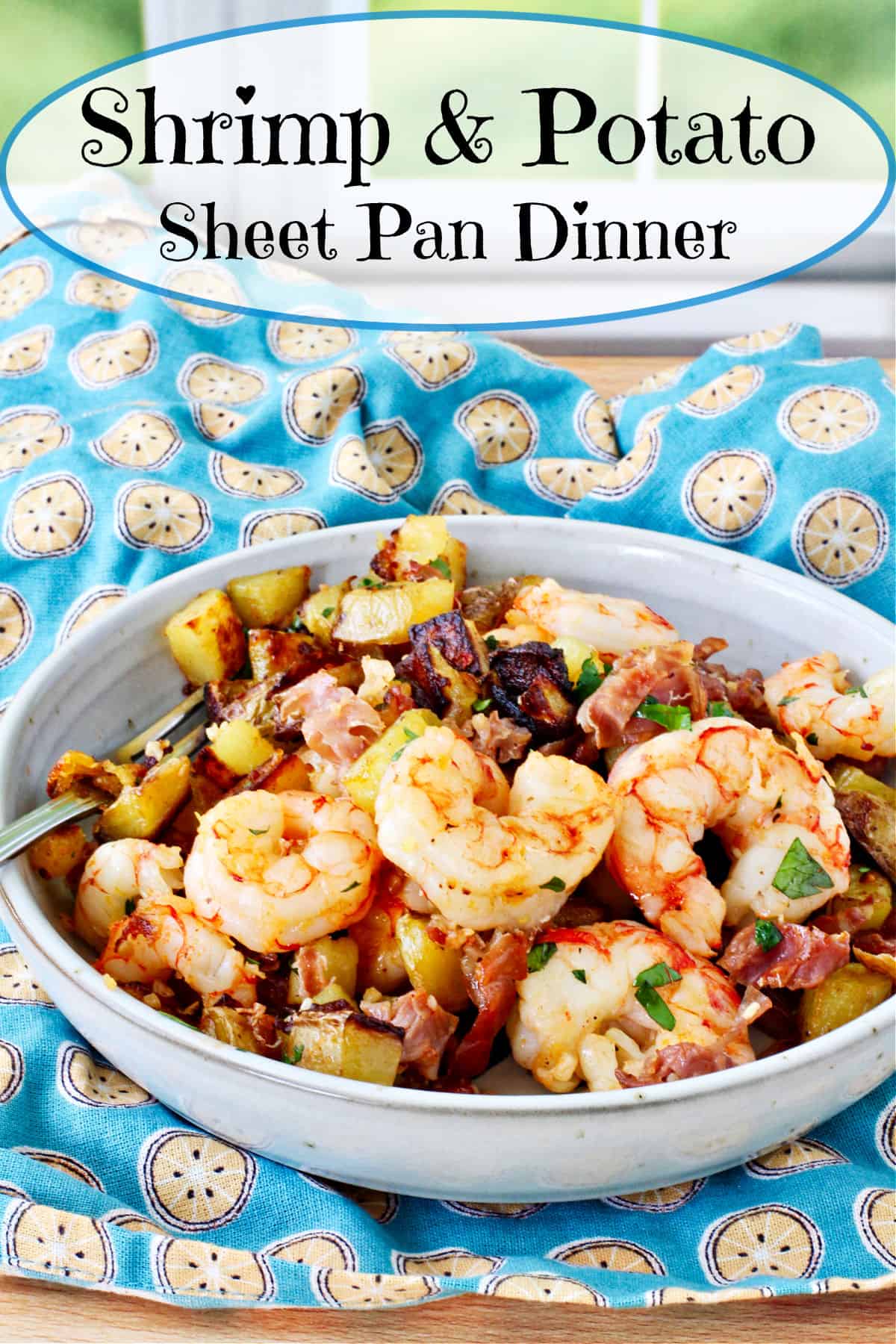 Sheet Pan Shrimp, Roasted Potatoes, & Prosciutto in a gray bowl.