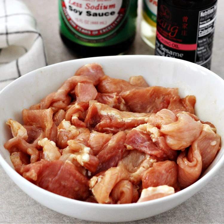 Pork strips for quick and easy pork and cabbage stir fry bowls in a bowl with marinade