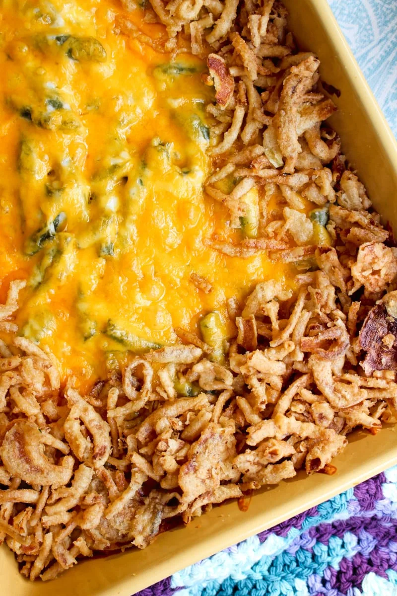 Sour Cream Green Bean Casserole is a no mushroom, no canned soup version of the classic side dish that is made with fresh green beans, creamy sour cream, sharp cheddar cheese, and french fried onions.  This recipe feeds a crowd!  #greenbeans #sidedish #greenbeancasserole