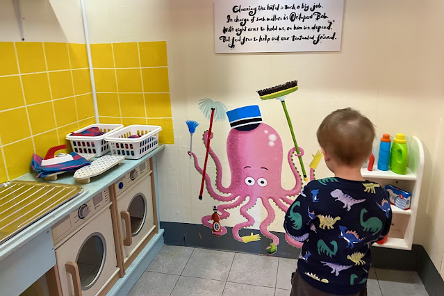 In the role play laundry room there are washing machines, ironing, vacuums and mops