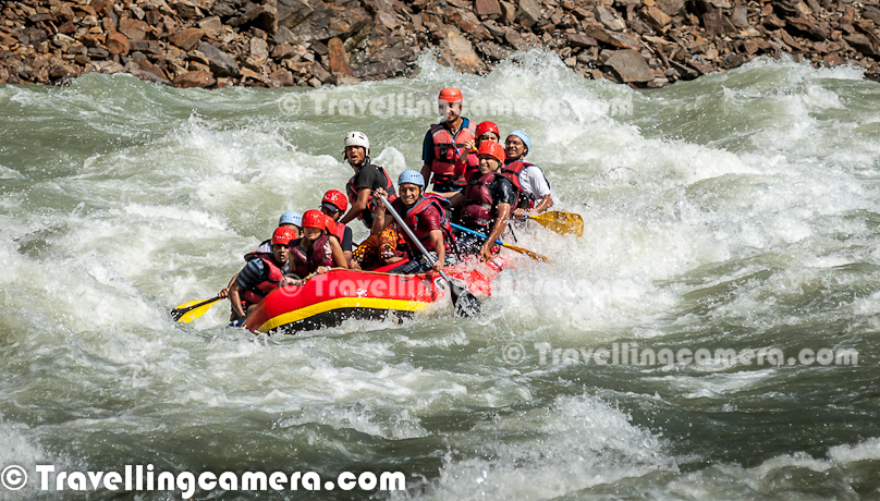 Rafting or white water rafting is one of the challenging recreational outdoor activity using an inflatable raft to navigate a river or other bodies of water having different levels of water-current. This is usually done on white water or different degrees of rough water, in order to thrill and excite the raft passengers. Rafting is considered an extreme sport, as it can be dangerous as times. This Photo Journey shares some of the photographs of Rafting in Risikesh, which is one of the popular places in India to do White Water Rafting.Recently we were in Rishikesh with office friends and Rafting was one of the top item in our list of things we wanted to do. We started in bus from Aspen Camps in Rishikesh and then boarded to jeeps with rafts. We had to start from Marine Drive which is a huge Ganges beach with enough space for folks to prepare and get started. Marine Drive is a place, strategically identified to start Rafting. Shivpuri is another preferred place to start Rafting. Idea is to make people comfortable with various types of water-rapids and then gradually start enjoying various stretches in river. Ganges provides a good range of water rapids and makes rafting an unmatchable experience.Rishieksh is one of the main places to do rafting in North India. Long time back I had done rafting in Vyas River near Kullu and that time all other rafters were professionals and I was covering a particular camp for Tourism Development program. Since I was not much involved in rafting activities, I couldn't enjoy it much that time. At Rishikesh, we had a wonderful coach/leader, who made rafting experience as great fun.After reaching Marine Drive Ganges beach, everyone of us got life jackets, a pedal and helmet. All three important things were with us and coach told us the best ways of using these three. All set with tight life-jacket, well settled helmet and appropriately gripped pedals we stepped into the raft after cleaning our feet in ganges water. It's recommended not to bring sand particles inside the raft, which can harm later. The coach threw chilling ganges water on us to start the journey in chilled water of ganges with different current levels. Coach with one of other Rafting professional entered into the raft. Then he briefed everyone of us about different commands like fast forward, move backward, stop etc. Initially it was difficult for us to gram every details of each command, but every command was very important for best rafting experience.Apart from basic Rafting commands, coach/leader also tells about basic rules of White Water Rafting. He also understands about each person sitting in the raft about their past experience with water. He also shares some basic steps for people who are not comfortable while sitting in raft. Of course, there are some standard rules to sit on a raft and make yourself comfortable even when body needs to stick with raft through feet in a particpular position. The Thumb rule is to listen your coach and follow him without any alternation, even in difficult situation. Idea is to trust the coach/Leader and follow his/her commands with any panic.So we started with baby steps and raft started moving towards Rishikesh (Lakshman Jhoola). For first 10 minutes, we were really slow and it was more of practice session, wehere coach was making us prepared for following his commands throughout the whole stretch we had to do in river. After practicing all the commands and moving our raft in circle, coach/leader asked us to stand on boundaries of raft and balance with pedal mounted on raft top. None of us could gather courage to stand on the boundaries and negotiated with coach/leader to stand inside the raft and try to balance with pedals. It was one of the major test for us and raft moves a lot. Many times, some of us stumbled and others were getting impacted because of imbalance. This task completed and coach/leader asked us to move forward.First we encountered Good Morning Rapid which is the beginning of Rafting experience. Good Morning rapid always come of the way and it doesn't matter that what was your starting point :). It was very basic but yet exciting because of first encounter with relatively fast flow of water-waves. Before hitting the rapid, some of the screaming while others were laughing to hide the fear :)All these photograph in this Photo Journey are clicked day before we did rafting. One day before we did rafting, we kept going to different places around river bed to shoot rafts sailing through high rapids of Ganges white water. Above photograph shows one of the raft getting up side down at Golf Course. One of the other leader jumped into the water to rescue raft and then every rafter. Within 5-8 minutes everyone was back on top of raft and moved forward towards Laxman Jhoola, which was end point. In such situations, ideally, everyone should listen carefully to what leader says and follow with panic. Things can get worse in case of avoidance of leader commands.The modern rafts are inflatable boats, consisting of very durable, multi-layered rubberized (hypalon) or vinyl fabrics (PVC) with several independent air chambers. The length varies between 3.5 meters and 6 meters, the width between 1.8 meters and 2.5 meters. The exception to this size rule is usually the packraft, which is designed as a portable single-person raft and may be as small as 1.5 metres long and weigh as little as 1.8 kilograms.Rafts come in a few different forms. In Europe and Australasia, the most common is the symmetrical raft steered with a paddle at the stern. Other types are the asymmetrical, rudder-controlled raft and the symmetrical raft with central helm (oars) or Stern Mounts with the oar frame located at the rear of the raft. Rafts are usually propelled with ordinary paddles and or oars and typically hold 4 to 12 persons. In Russia, rafts are often hand made and are often a catamaran style with two inflatable tubes attached to a frame. Pairs of paddlers navigate on these rafts. Catamaran style rafts have become popular in the western United States as well, but are typically rowed instead of paddled.Check out more at - http://en.wikipedia.org/wiki/RaftingAfter Good-Morning rapid, we crossed - Black Money, Three Blind Miles, Cross Fire, Shivpuri, Return to center, Roller Coaster, Tea off, Golf Course, Club House, Initiation, Body Surfing, maggie point & Cliff jumping, Double Trouble, Hilton and fianally Ram Jhoola. I went till Golf Course only and most of the other rafts from our group ended at Lakshman Jhoola.The most suitable time for River Rafting in Rishikesh is from September to November and from March to April-May. One of the best rivers in the world to experience the sheer exhilaration of white water rafting, it is the sheer invincible power of the Ganga river that often attracts the adventurer to the challenging sport of river rafting at Rishikesh.Generally White Water Rapids are divided into 6 levels of difficulty.Grade 1: Very small rough areas, might require slight maneuvering. (Skill Level required is very BasicGrade 2: Some rough water, maybe some rocks, might require some maneuvering. (Skill level: basic paddling skillGrade 3: Whitewater, small waves, maybe a small drop, but no considerable danger. May require significant maneuvering. (Skill level: experienced paddling skills)Grade 4: Whitewater, medium waves, maybe rocks, maybe a considerable drop, sharp maneuvers may be needed. (Skill level: whitewater experi\\Grade 5: Whitewater, large waves, large volume, possibility of large rocks and hazards, possibility of a large drop, requires precise maneuvering. (Skill level: advanced whitewater experience)Grade 6: Class 6 rapids are considered to be so dangerous that they are effectively unnavigable on a reliably safe basis. Rafters can expect to encounter substantial whitewater, huge waves, huge rocks and hazards, and/or substantial drops that will impart severe impacts beyond the structural capacities and impact ratings of almost all rafting equipment. Traversing a Class 6 rapid has a dramatically increased likelihood of ending in serious injury or death compared to lesser classes. (Skill level: successful completion of a Class 6 rapid without serious injury or death is widely considered to be a matter of great luck or extreme skill and is considered by some as a suicidal venture)In Rishikesh, we have crossed rapids of Level-3 difficulty as max. But it was great fun to face level three rapids. Water comes on to your body and pushes back and sometimes people get down into the water due to thrust.White water rafting can be a dangerous sport at times, especially if basic safety precautions are not observed. Both commercial and private trips have seen their share of injuries and fatalities, though private travel has typically been associated with greater risk. Depending on the area, safety regulations covering raft operators may exist in legislation. These range from certification of outfitters, rafts, and raft leaders, to more stringent regulations about equipment and procedures. It is generally advisable to discuss safety measures with a rafting operator before signing on for a trip. The equipment used and the qualifications of the company and raft guides are essential information to be considered.Like most outdoor sports, rafting in general has become safer over the years. Expertise in the sport has increased, and equipment has become more specialized and increased in quality. As a result the difficulty rating of most river runs has changed.