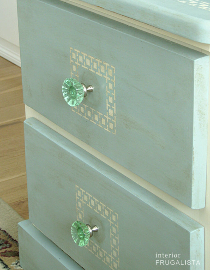 A pine bedside table makeover with pretty green glass knobs.