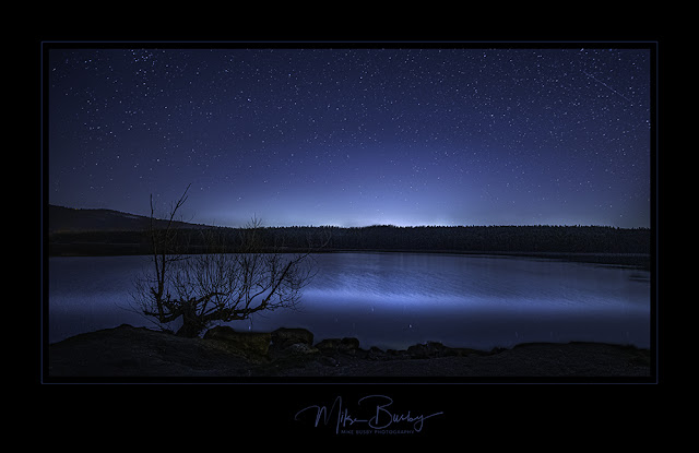 A night scene feature smooth blue waters and the stars in the sky.