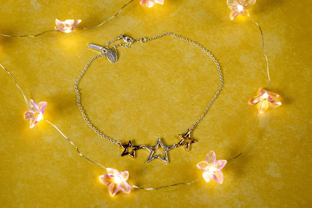 A necklace with 3 hammered metal star outlines from Kasbah clothing
