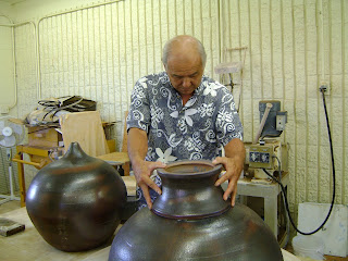 Kauai CC professor Wayne Miyata checks bottom section of sacred ball for the Hall of Compassion