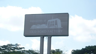 a bill board viewing from the road saying Ford Factory