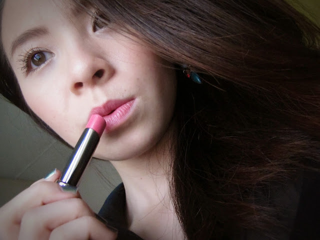Girl putting on lipstick