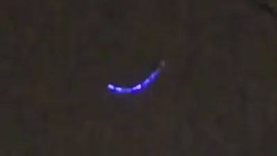 Electric blue UFO sighting filmed by many onlooker's.