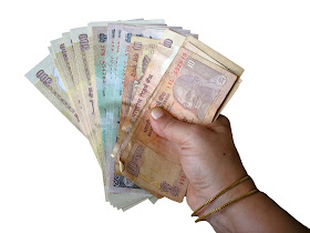 hand holding rupee notes cutout