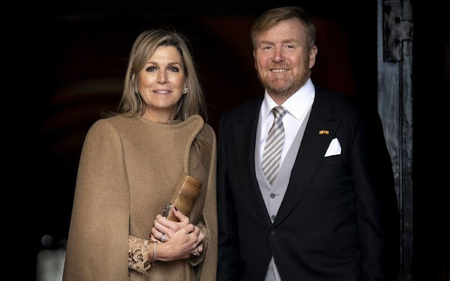 Queen Maxima wore a camel wool cape coat by Claes Iversen, and a tobacco brown Serval lace midi dress by Claes Iversen