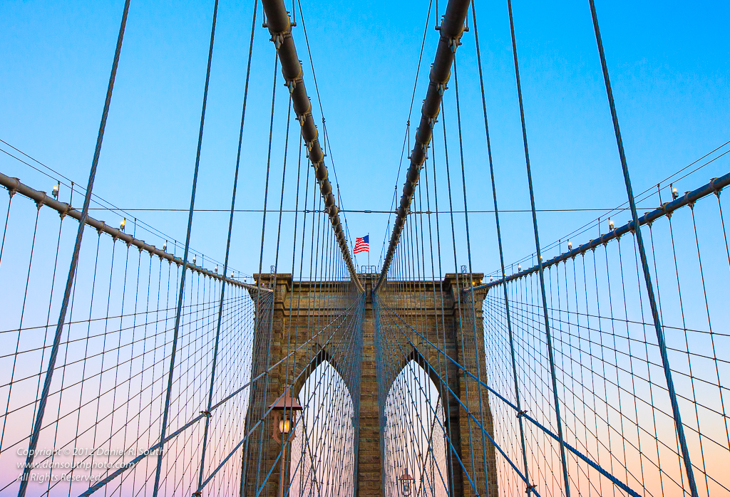 a photo of the brooklyn bridge at sunset