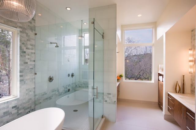 Photo of modern bathroom with the shower cabin and bathtub
