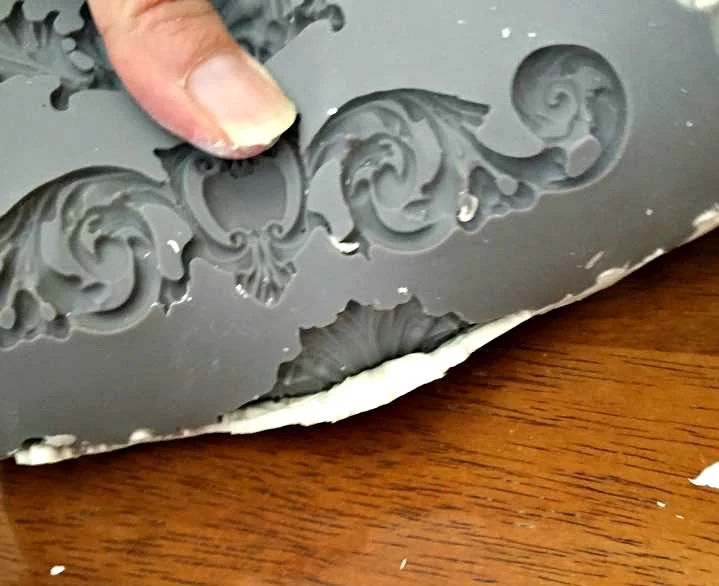 Bend the mould to release the clay