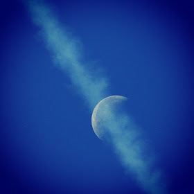 jet contrails over moon