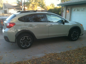 Desert Khaki 2013 Subaru XV Crosstrek parked in a suburban driveway