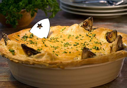 A Stargazy Pie with the Stargazy Studios logo replacing one of the fish heads.