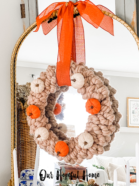 DIY hand knit chunky wreath with pumpkins hanging on mirror