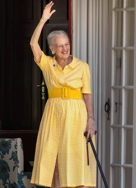 Queen Margrethe wore a saffron yellow gingham cotton-blend shirt dress. Princess Benedikte wore an orange flowers skirt by Gustav