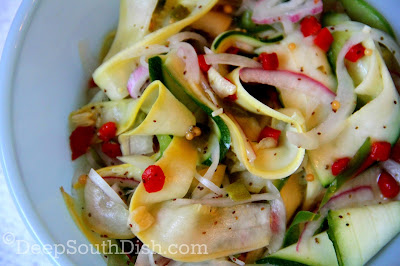 A marinated squash salad using summer vegetables, including squash, zucchini, vidalia onion, sweet bell pepper and jalapenos and dressed in a horseradish infused, sweet and sour "Fire and Ice" vinaigrette.