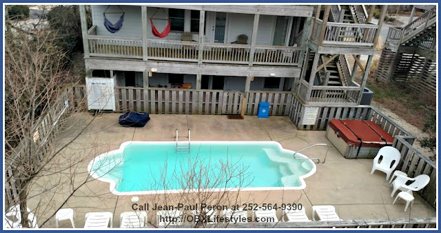 Aside from a heated swimming pool, this Outer Banks NC home for sale in Ocean Sands also has a hot tub and partial bathroom near the pool area.