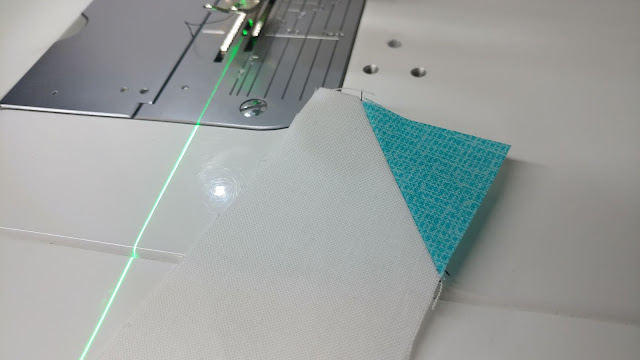 Using a sewing machine laser to sew stitch and flip corners